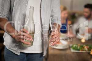 Mid section of man holding champagne