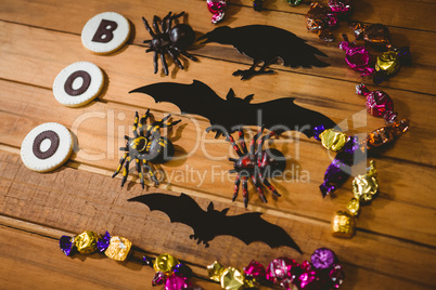 Cookies with boo text by decorations and chocolates table