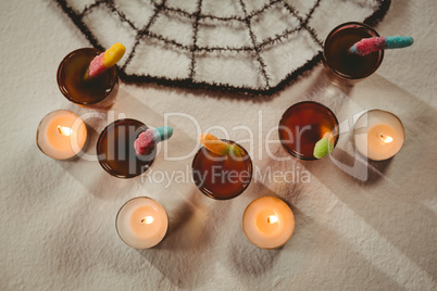 Overhead view of candies with drinks and candles