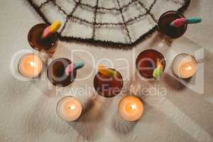 Overhead view of candies with drinks and candles