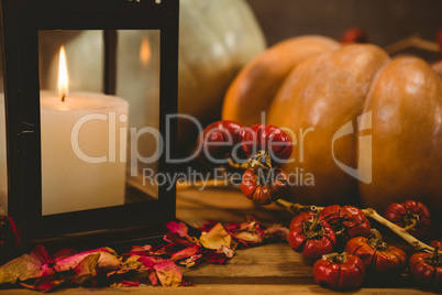 Pumpkins by candle on table during Halloween