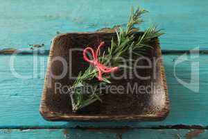 Tied rosemary in wooden bowl