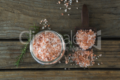 Himalayan salt and rosemary on wooden table