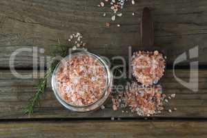 Himalayan salt and rosemary on wooden table