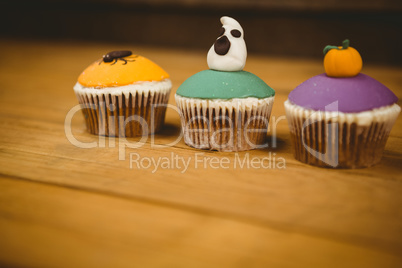 Colorful cup cakes on table during Halloween