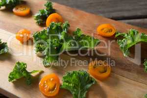 Close up of kale and tomato slices on cutting board