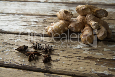High angle view of fresh gingers and star anise on weathered table