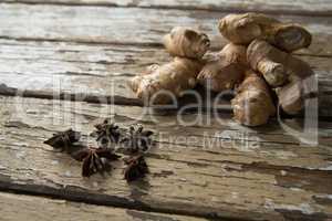 High angle view of fresh gingers and star anise on weathered table
