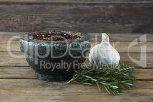 Garlics, rosemary and mix peppercorns on chopping board