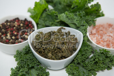 Close up of peppercorn and salt with kale