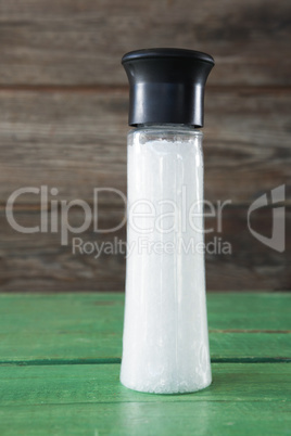 Close-up of white sea salt in shaker bottle