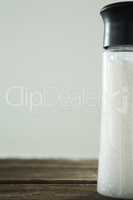 Salt shaker on wooden table