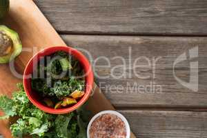 Fresh vegetable with cutting board at wooden table
