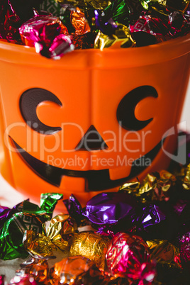 Close up of orange bucket with colorful chocolates