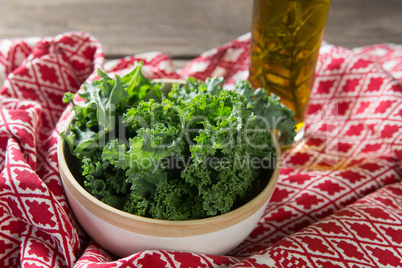 Fresh kale leaves with oil bottle and fabric