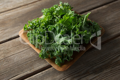 Fresh kale in bowl on table
