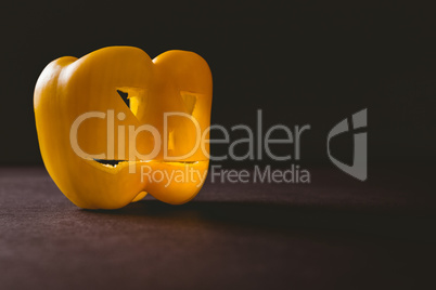 Carved yellow bell pepper on table