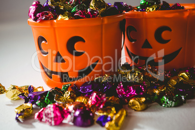 Close up of orange buckets with multicolored chocolates