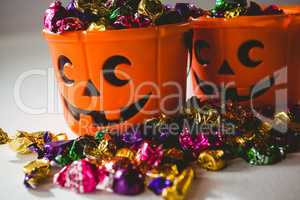Close up of orange buckets with multicolored chocolates