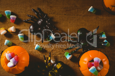 Candies with decorations on wooden table