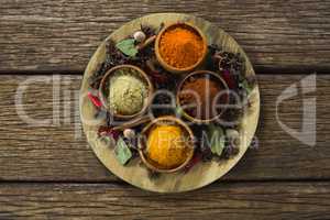 Various spices on wooden board