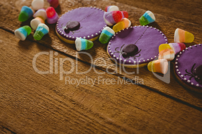 Close up of Halloween cookies with candies on table