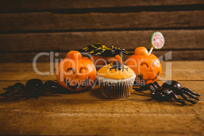 Halloween decorations with cup cake on table