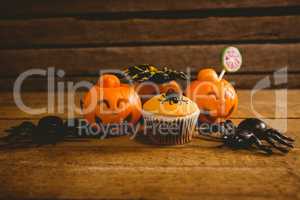 Halloween decorations with cup cake on table