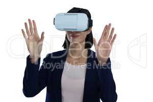 Businesswoman gesturing while using virtual reality headset