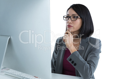 Businesswoman working on desktop pc Businesswoman working on desktop pc