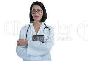 Portrait of happy female doctor standing with arms crossed