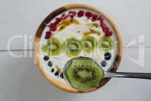 Sliced kiwi on spoon