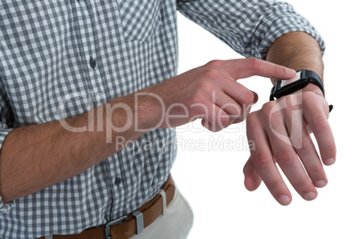 Mid section of man using smartwatch