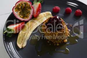 Healthy breakfast with fruits in a serving plate