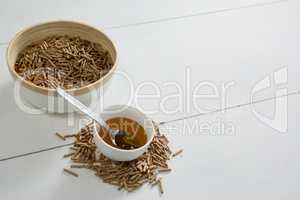 Cereal bran sticks and honey in bowl