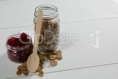 Raspberry and wheat flakes in glass jar