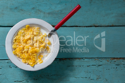 Breakfast cereals in bowl on wooden table