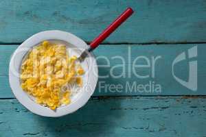 Breakfast cereals in bowl on wooden table