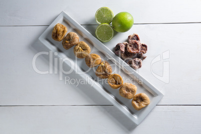 Overhead view of figs with lemons in plate