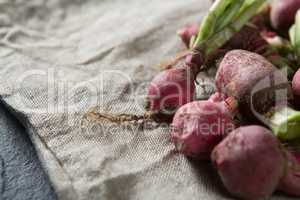 Close-up of red radishes on burlap