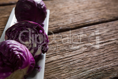 Red cabbage in tray on wooden table