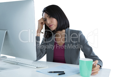 Tired businesswoman sitting at desk