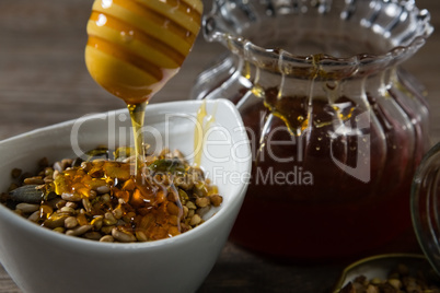 Honey pouring into a cereal bowl