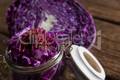 Chopped and halved red cabbage on wooden table