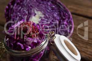 Chopped and halved red cabbage on wooden table