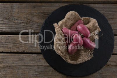 Sweet potatoes on a textile in a tray