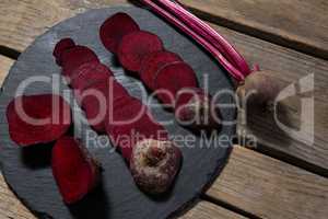 Slices of beetroots arranged on chopping board