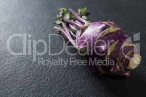 Close-up of purple root vegetable on slate