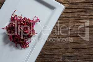 Chopped beetroots in a tray on wooden table