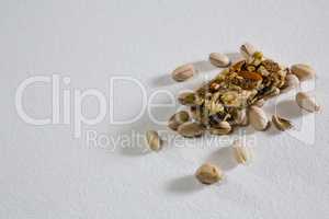 Pistachio and granola bar on white background